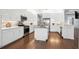 Modern kitchen with white cabinets, stainless steel appliances, and an island at 4919 Pamplona Ct., Wimauma, FL 33598