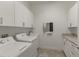 Bright laundry room featuring washer, dryer, and ample cabinet space at 4919 Pamplona Ct., Wimauma, FL 33598