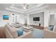 Bright and airy living room with hardwood floors and stylish furniture at 4919 Pamplona Ct., Wimauma, FL 33598
