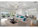 Spacious living room with hardwood floors, comfortable furniture, and access to a patio at 4919 Pamplona Ct., Wimauma, FL 33598