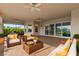 Relaxing covered patio with wicker furniture and access to pool at 4919 Pamplona Ct., Wimauma, FL 33598