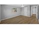 Well-lit bedroom with wood-look floors and access to hallway at 4923 Azalea Dr, New Port Richey, FL 34652