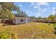 Backyard view of a renovated house with gray siding at 4923 Azalea Dr, New Port Richey, FL 34652