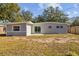 Modern house exterior with gray siding and large windows at 4923 Azalea Dr, New Port Richey, FL 34652