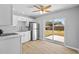 Modern kitchen with white cabinets, stainless steel appliances, and sliding door to backyard at 4923 Azalea Dr, New Port Richey, FL 34652