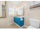 Charming bathroom with blue vanity, tiled walls, and a shower at 1010 59Th N Ave, St Petersburg, FL 33703
