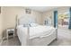 Spacious bedroom with a white bed frame and teal colored accents at 1010 59Th N Ave, St Petersburg, FL 33703