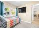 Small bedroom with a daybed, large TV, and view into hallway at 1010 59Th N Ave, St Petersburg, FL 33703