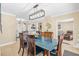 Bright dining room features a blue table with wooden chairs, and a view into the living room at 1010 59Th N Ave, St Petersburg, FL 33703
