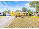 Charming yellow house with well-manicured lawn and American flag at 1010 59Th N Ave, St Petersburg, FL 33703