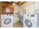 Bright laundry room with washer, dryer, and cabinets at 1010 59Th N Ave, St Petersburg, FL 33703