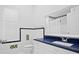 Clean bathroom with blue quartz countertop and white cabinets at 10106 Radcliffe Dr, Tampa, FL 33626