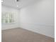 Spacious bedroom with neutral carpeting and plantation shutters at 10106 Radcliffe Dr, Tampa, FL 33626