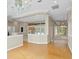 Open dining area with hardwood floors, multiple light fixtures, and views to other rooms at 10106 Radcliffe Dr, Tampa, FL 33626