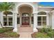 Elegant front door entrance with columns and brick pathway at 10106 Radcliffe Dr, Tampa, FL 33626