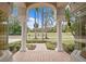 Front entryway with columns and a view of a manicured lawn and trees at 10106 Radcliffe Dr, Tampa, FL 33626