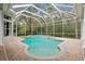 Inviting screened pool and spa with lush landscaping at 10106 Radcliffe Dr, Tampa, FL 33626