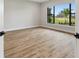 Light-filled bedroom with wood-look flooring and large windows at 10639 Ruffino Ct, Trinity, FL 34655