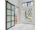 Bright and spacious entryway with a modern barn door and double French doors at 10639 Ruffino Ct, Trinity, FL 34655