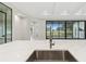 Modern kitchen features a large island with quartz countertops and stainless steel appliances at 10639 Ruffino Ct, Trinity, FL 34655