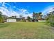 Spacious backyard with large grassy area, shed, and mature trees at 11303 Leprechaun Dr, Riverview, FL 33569