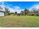 Large grassy backyard with a view of the house at 11303 Leprechaun Dr, Riverview, FL 33569