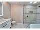 Modern bathroom with a frameless shower, a soaking tub, and white vanity at 11303 Leprechaun Dr, Riverview, FL 33569