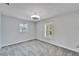 Spacious bedroom with gray carpet and two windows at 11303 Leprechaun Dr, Riverview, FL 33569