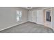 Bright bedroom featuring gray carpet and a window with shutters at 11303 Leprechaun Dr, Riverview, FL 33569
