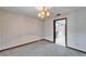 A formal dining area with carpeting, chandelier, and access to the kitchen at 11303 Leprechaun Dr, Riverview, FL 33569