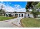 White single-story home with a brick walkway and arched entryway at 11303 Leprechaun Dr, Riverview, FL 33569
