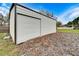 Side view of a metal garage with roll-up door at 11303 Leprechaun Dr, Riverview, FL 33569