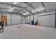 Spacious garage with double roll-up doors and storage at 11303 Leprechaun Dr, Riverview, FL 33569