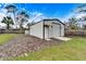 Metal garage with roll-up door and side entrance at 11303 Leprechaun Dr, Riverview, FL 33569