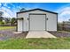 Large metal garage with roll-up door and side entrance at 11303 Leprechaun Dr, Riverview, FL 33569