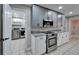 Updated kitchen with gray cabinets, granite countertops, and stainless steel appliances at 11303 Leprechaun Dr, Riverview, FL 33569