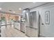 Kitchen with stainless steel refrigerator, gray cabinets, and pantry at 11303 Leprechaun Dr, Riverview, FL 33569