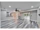 Open living area with wood-look floors, fireplace, and pool view at 11303 Leprechaun Dr, Riverview, FL 33569