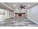 Bright living room with stone fireplace, vinyl flooring and access to the pool at 11303 Leprechaun Dr, Riverview, FL 33569