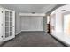 Versatile room with carpet, neutral walls and built-in shelving at 11303 Leprechaun Dr, Riverview, FL 33569