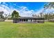 Screened pool area with a large deck and grassy yard at 11303 Leprechaun Dr, Riverview, FL 33569