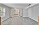 Spare bedroom with grey carpet and access to a formal dining room at 11303 Leprechaun Dr, Riverview, FL 33569