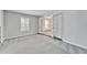 Grey carpeted spare bedroom with double french doors at 11303 Leprechaun Dr, Riverview, FL 33569