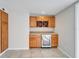 Wet bar with wood cabinets and wine cooler at 11303 Leprechaun Dr, Riverview, FL 33569