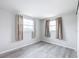 This bedroom features wood-look floors, neutral walls, and curtains at 11801 104Th St, Largo, FL 33773