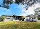 Ranch-style home with carport and well-manicured lawn at 11801 104Th St, Largo, FL 33773