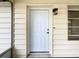 Clean white front door of home with covered porch and exterior light fixture at 11801 104Th St, Largo, FL 33773