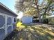 Large backyard with shed, covered patio, and mature oak tree at 143 44Th N Ave, St Petersburg, FL 33703