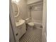 Updated bathroom with white vanity, bathtub, and black and white tile floor at 143 44Th N Ave, St Petersburg, FL 33703