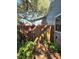 Backyard walkway to a wooden gate and lush plants at 143 44Th N Ave, St Petersburg, FL 33703